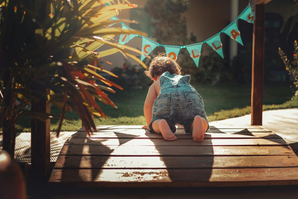 happy toddler crawling on floor.